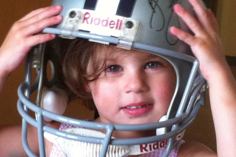 Elliott Githens smiling while wearing a football helmet